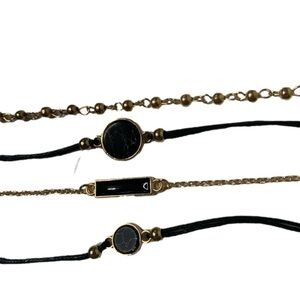 Golden black set of four bracelets